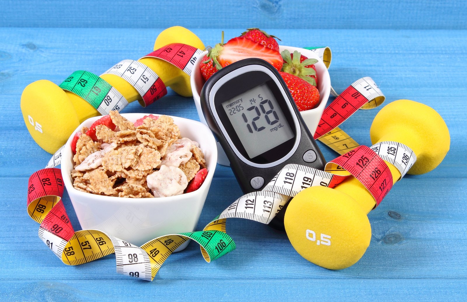 Glucometer with result sugar level, healthy food, dumbbells and centimeter, diabetes